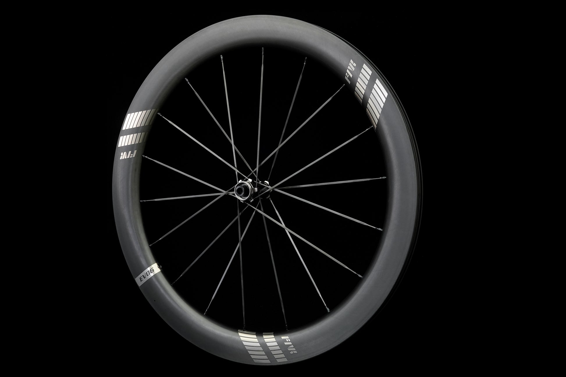 Bicycle wheel with black rim and carbon spokes on a black background