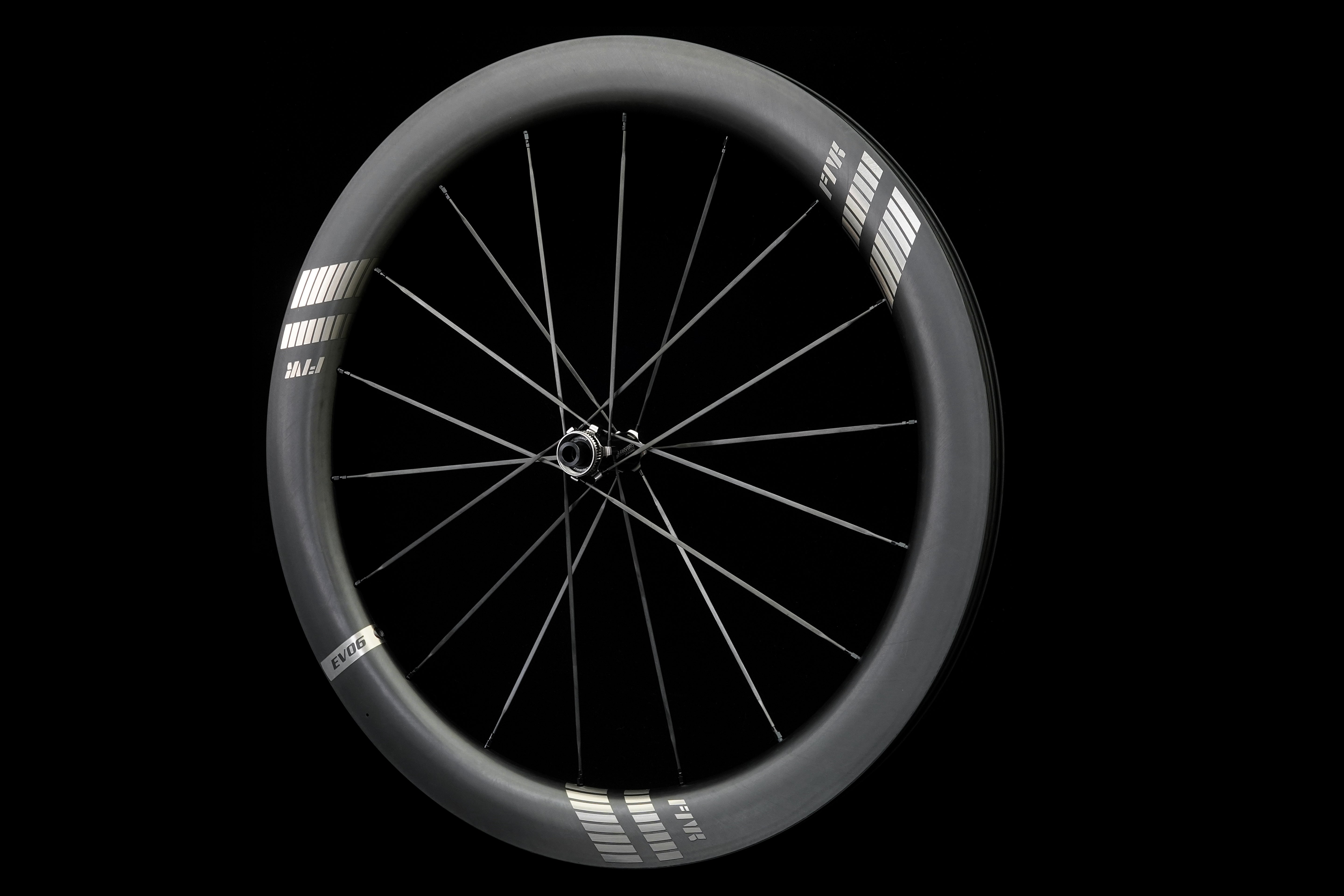 Bicycle wheel with black rim and carbon spokes on a black background