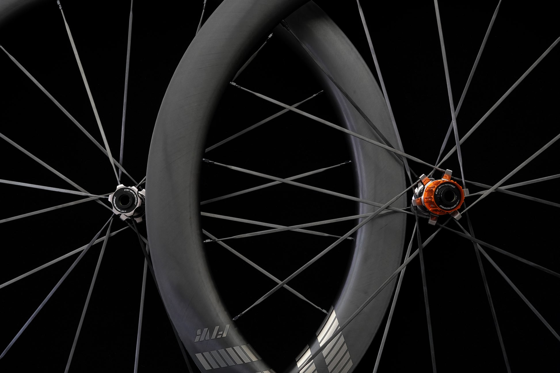 Orange ratchet hub with ceramic bearings Close-up of a bicycle wheel with a black background