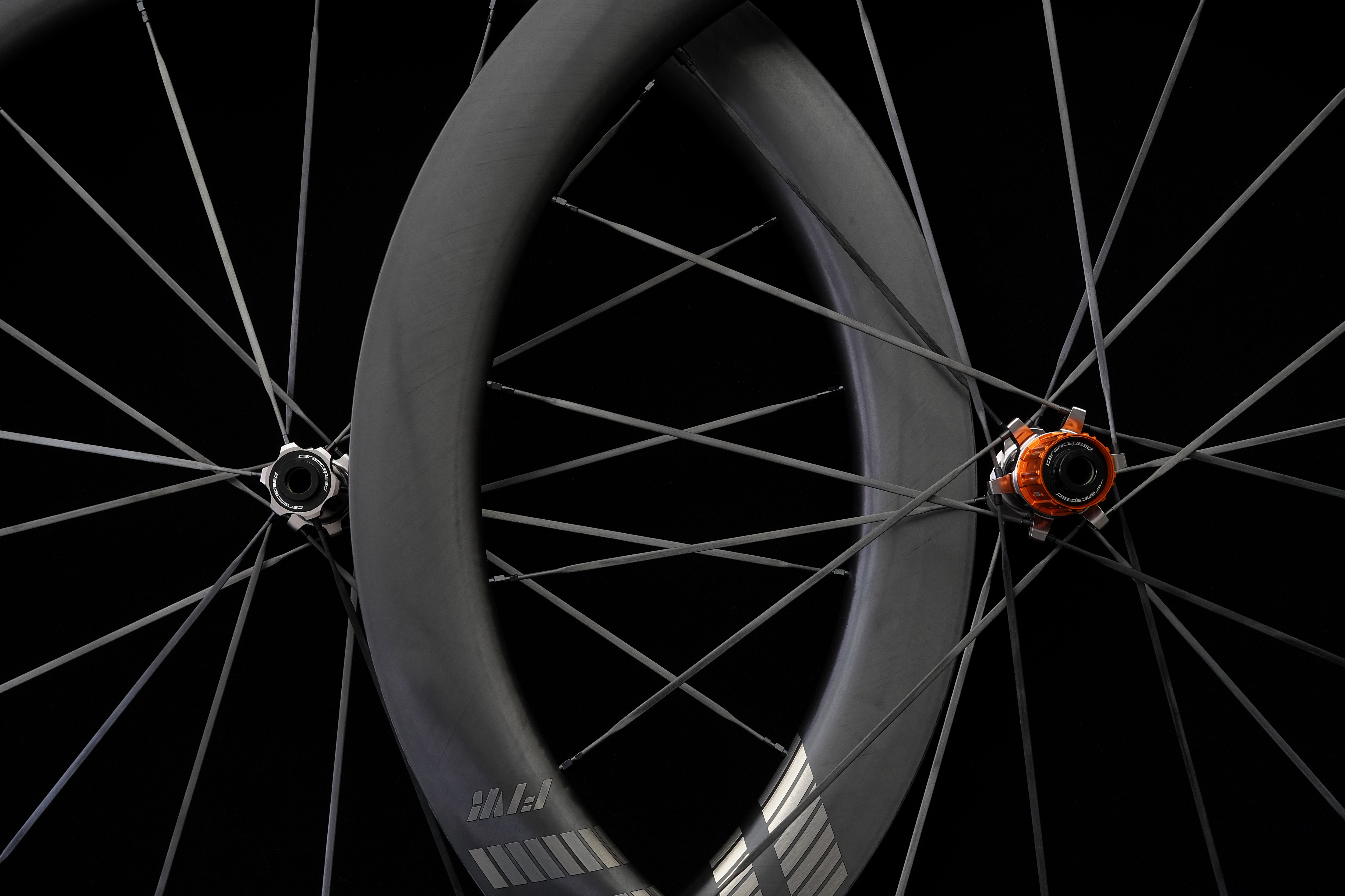 Orange ratchet hub with ceramic bearings Close-up of a bicycle wheel with a black background